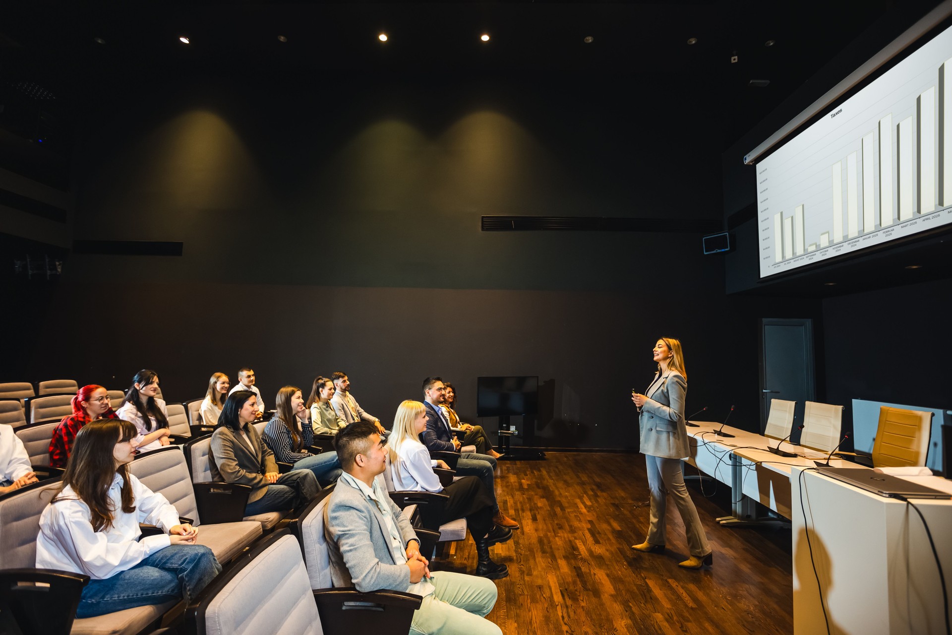 Female CEO having speech on press conference in convention center.